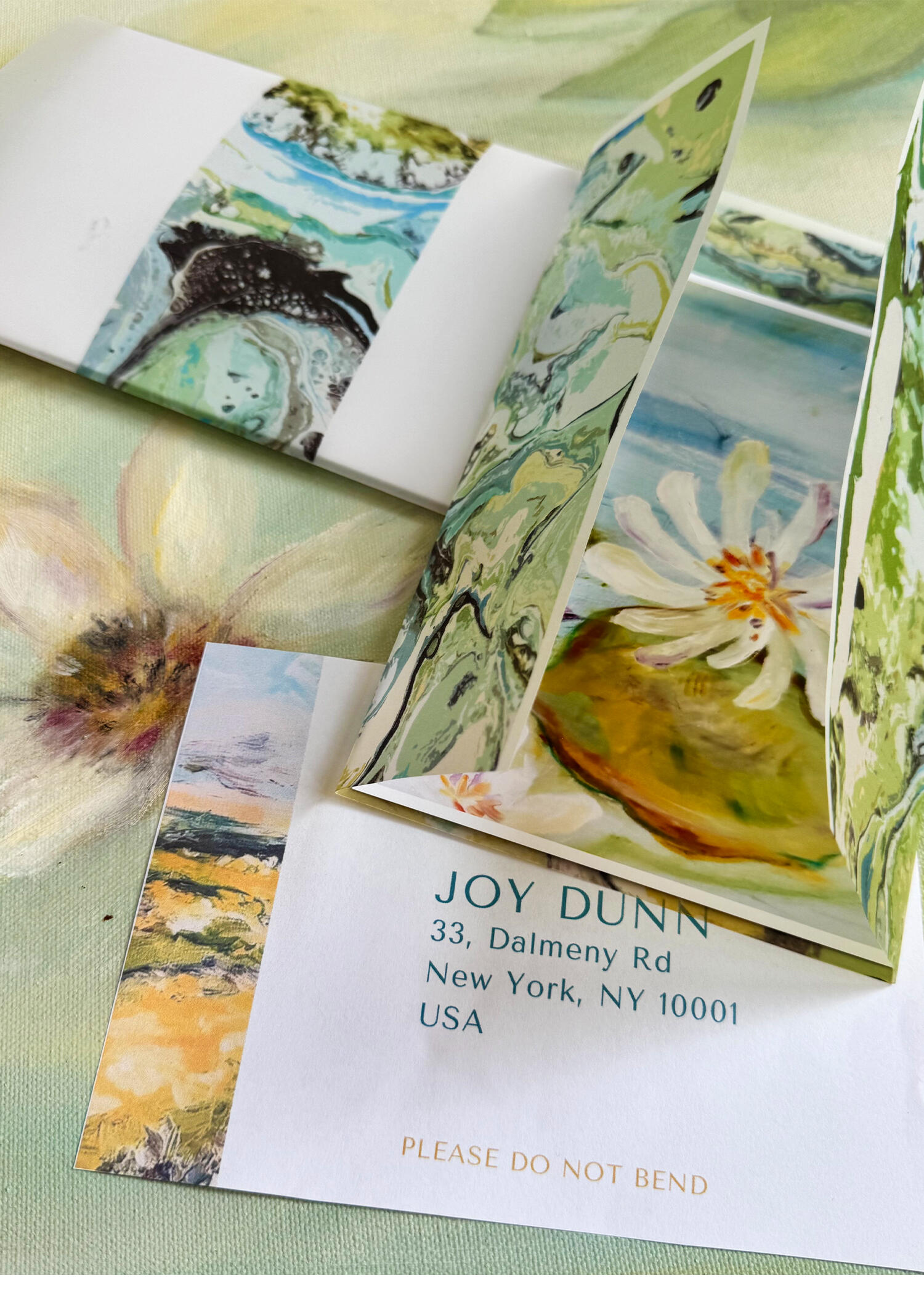 image of a collection of handwritten letters with an art print of a red barn and bales of hay.